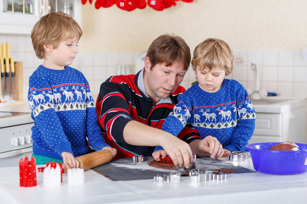 two little kid boys and dad baking gingerbread cookies - Photo, Image
