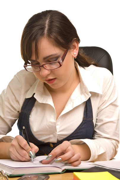Young businesswoman in glasses writing - 写真・画像