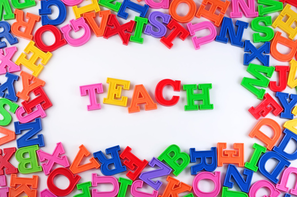 Teach written by plastic colorful letters on a white - Photo, Image