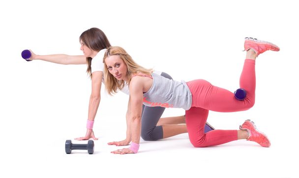 Two woman exercise with dumbbells - Foto, Bild