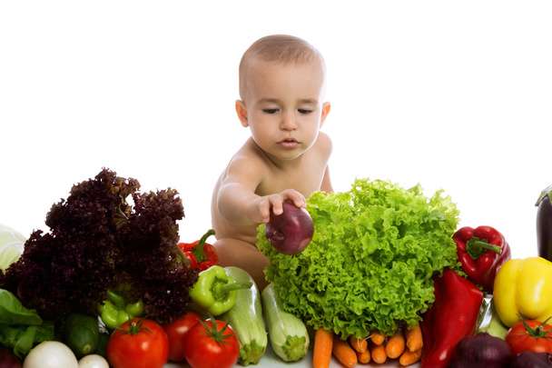 Baby with vegetables - Фото, изображение