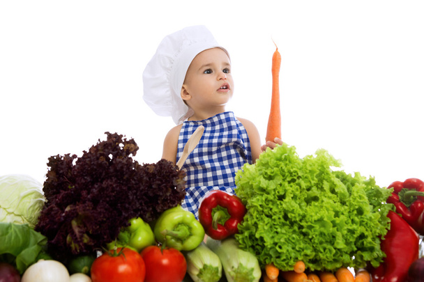 Beautiful kid boy wearing a chef hat with healthy food vegetable - Фото, изображение