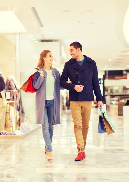 happy young couple with shopping bags in mall - Fotoğraf, Görsel