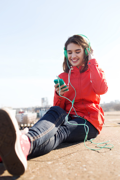 happy young woman with smartphone and headphones - Foto, Bild