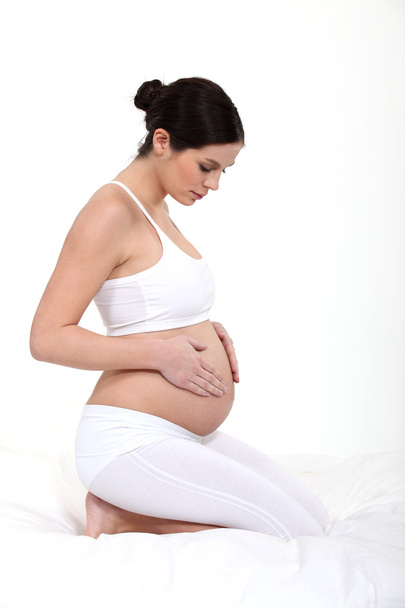 Pregnant woman touching belly - Fotografie, Obrázek