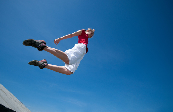 Beautiful woman jump into sky - Fotoğraf, Görsel