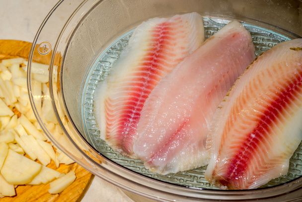 cooking red filets of tilapia on steam - Photo, Image