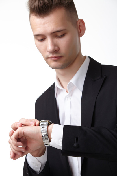 Businessman looking at watch - Foto, afbeelding