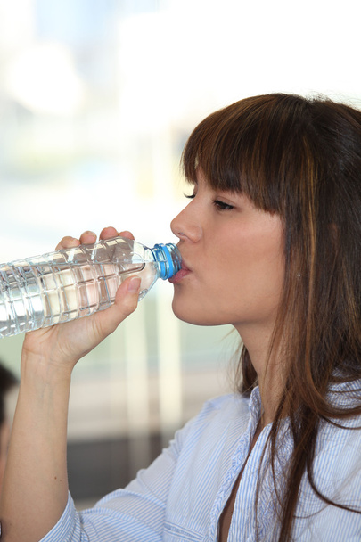 Woman drinking water from a bottle - Foto, imagen