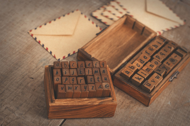 Wooden stamps alphabet and vintage envelopes - Photo, image