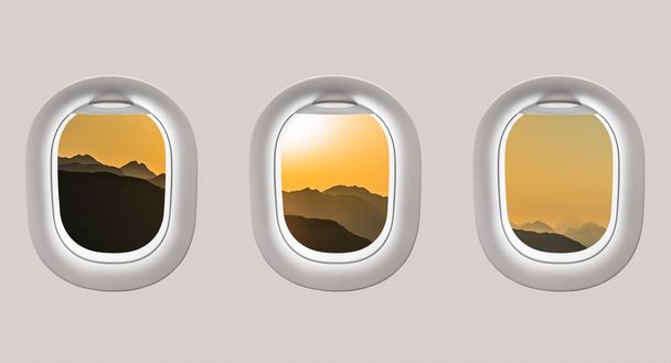 Κοιτώντας έξω από τα παράθυρα του ένα αεροπλάνο για τα βουνά και το ηλιοβασίλεμα - Φωτογραφία, εικόνα