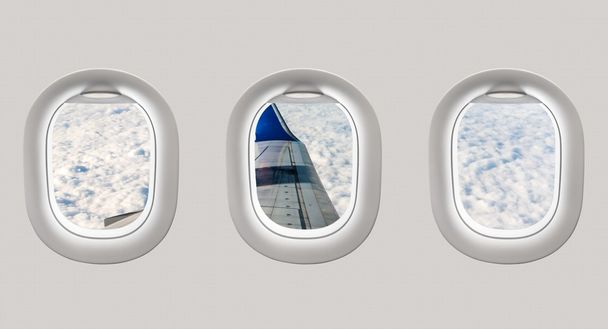 Looking out the windows of a plane to the aircraft wing and clou - Photo, Image