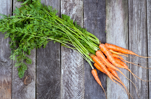 Fresh carrots on old wooden background - Photo, Image