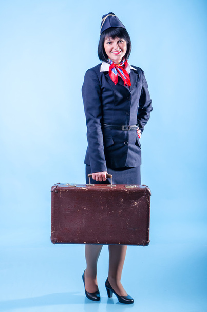 Young stewardess with suitcase. - Valokuva, kuva