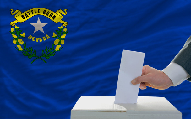 Mann bei der Abstimmung über Wahlen vor Flagge uns Staatsflagge nevada - Foto, Bild