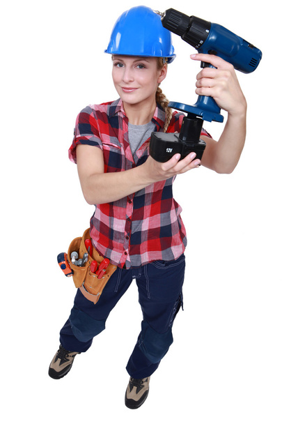 Tradeswoman holding a battery-powered power tool - Fotoğraf, Görsel
