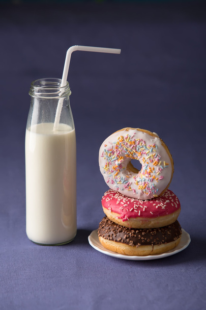 Donut with milk at violet background - Photo, image