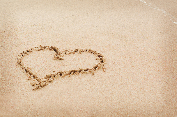 The heart drawn on the sand in beach - Photo, Image