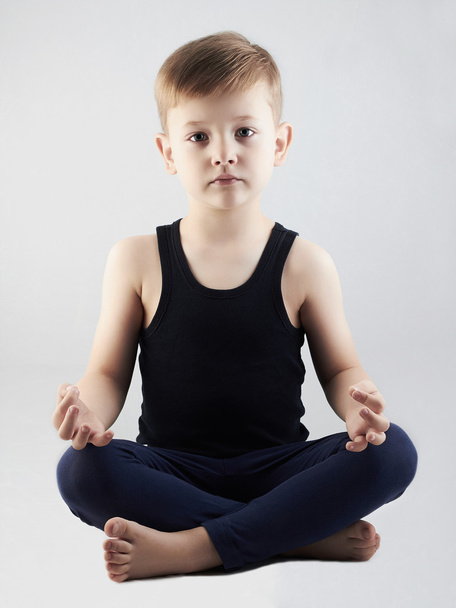 Yoga boy.child in the lotus position.children meditation and relaxation - Fotoğraf, Görsel