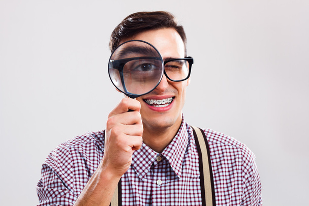 nerd man with magnifying glass - Φωτογραφία, εικόνα
