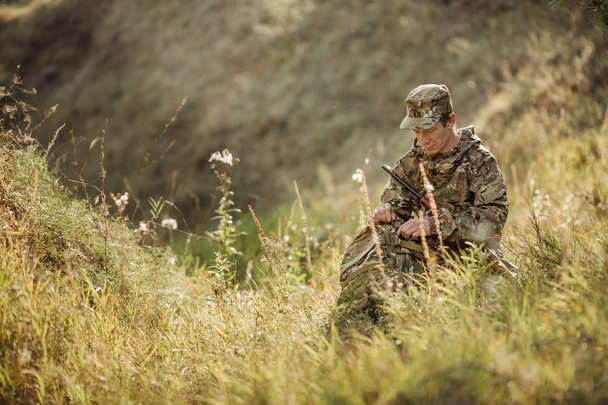 hunter in camouflage clothes ready to hunt with hunting rifle - Photo, Image