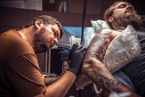 Szakmai tattooer mutatja a folyamat, hogy egy tetoválás, tetováló szalon - Fotó, kép