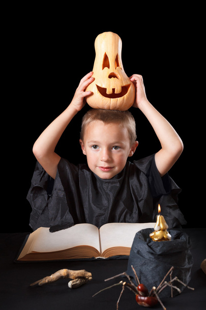 Boy wearing halloween costume with pumpkin - Foto, afbeelding