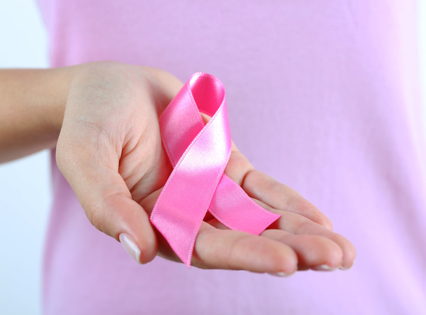 Pink ribbon in woman's hands - 写真・画像