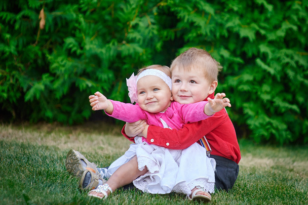 happy sister and brother together in the park hugging - Foto, Imagen