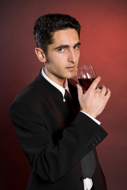 Glamour man with bocal of red wine. - Фото, изображение