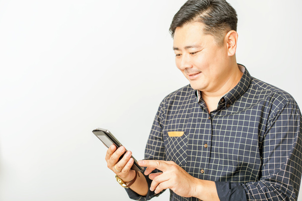 asian businessman using a mobile phone at white background - Photo, Image