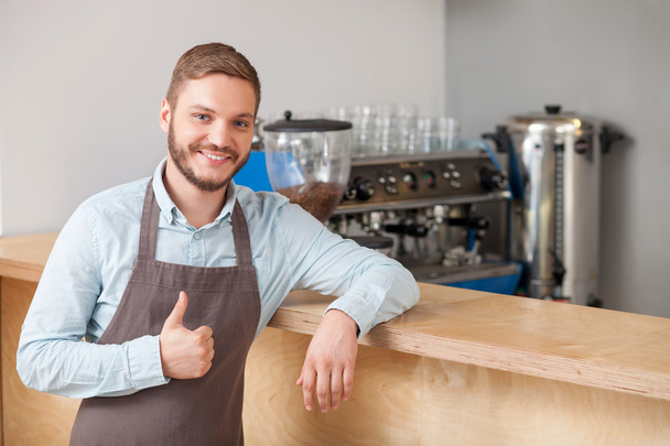 Cheerful male cafe worker is expressing positive emotions - Photo, image