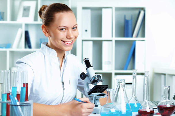 Young scientist working in laboratory - Фото, изображение