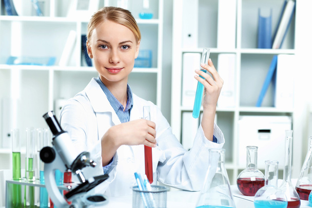 Young scientist working in laboratory - Фото, изображение