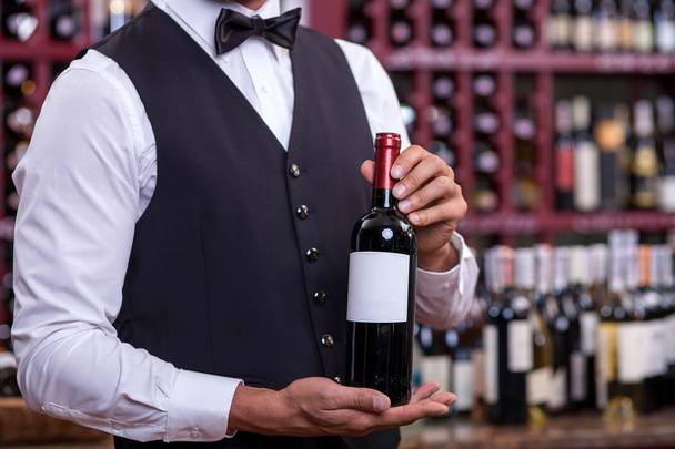 Professional young sommelier is working in liquor store - Φωτογραφία, εικόνα
