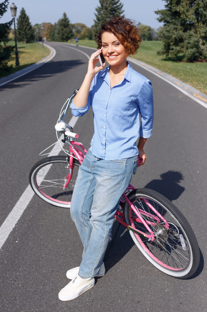 Active girl riding a bicycle - Zdjęcie, obraz