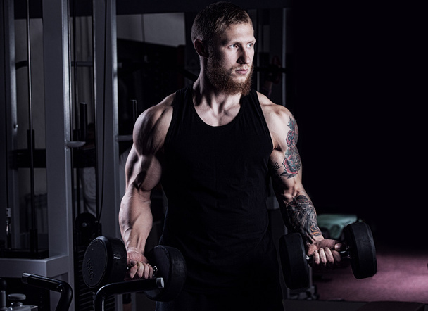 very power athletic guy bodybuilder , execute exercise with dumb - Foto, Bild