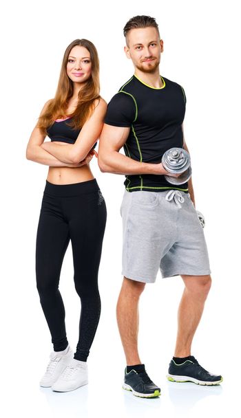 αθλητική άνδρας και γυναίκα με αλτήρες στο λευκό - Φωτογραφία, εικόνα