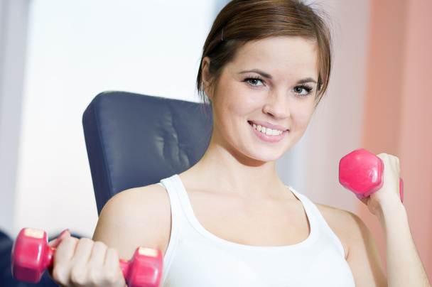 Beautiful sport woman doing exercise with dumbbell weight - Photo, Image