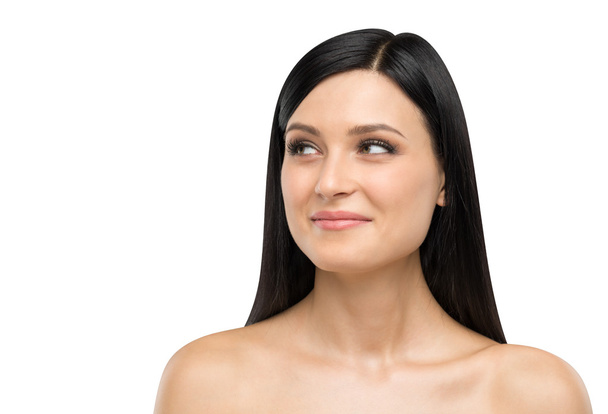 A portrait of a smiling brunette lady who is looking at something on the right side. Isolated on white background. - Φωτογραφία, εικόνα