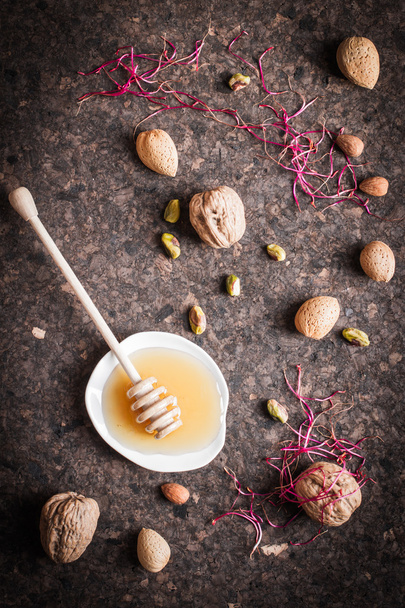 mix honey with nuts. appetizer wine - Zdjęcie, obraz