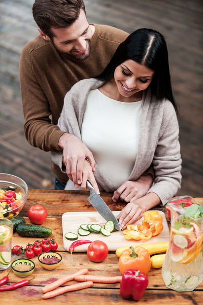 young couple preparing food together - Фото, зображення