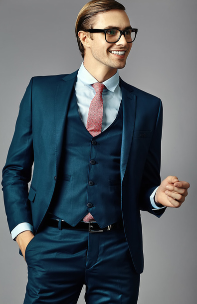 Young  elegant handsome  businessman male model in a suit and fashionable glasses, posing in studio - Φωτογραφία, εικόνα