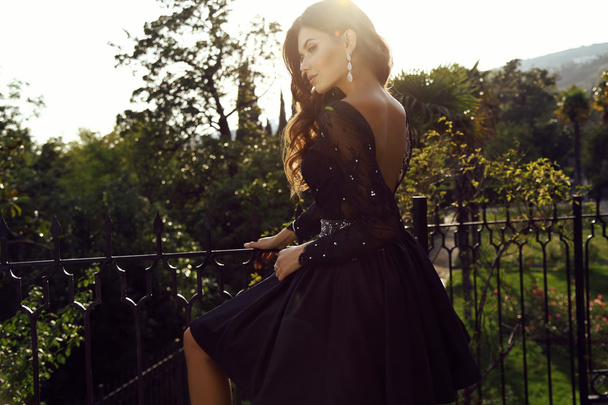 beautiful woman with dark hair wears elegant dress - Photo, Image