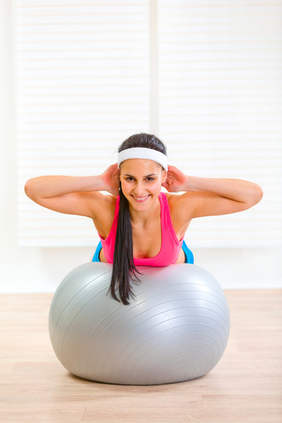 Happy fitness girl doing abdominal crunch on fitness ball - Photo, Image