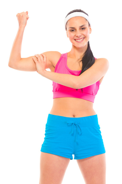Cheerful fitness young girl in sportswear showing her muscles - Fotó, kép