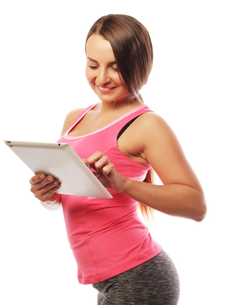 Young sporty woman using a digital tablet - Zdjęcie, obraz