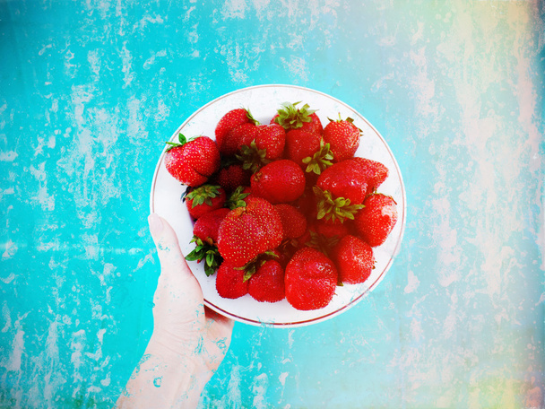 hand holding bright strawberries - Fotó, kép