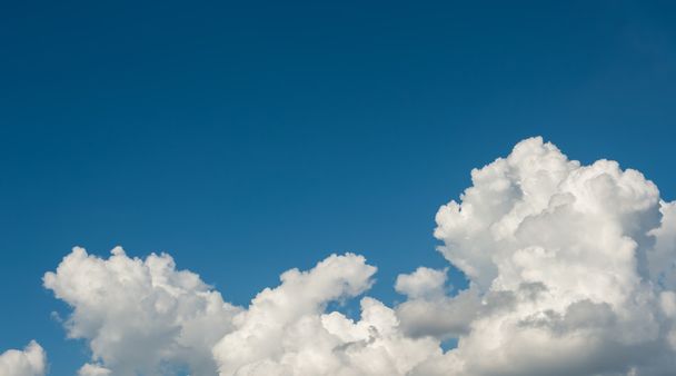 white cumulus clouds in the blue sky for background usage. - Photo, Image