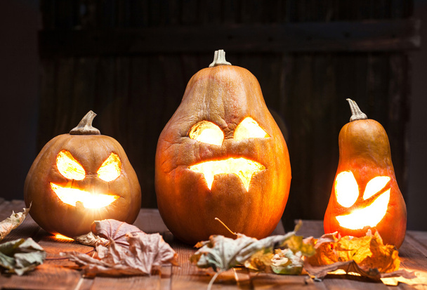 Jack o lantaarns Halloween pompoen gezicht op houten achtergrond - Foto, afbeelding